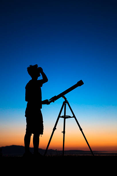 istock Boy on a clear night looking thru a telescope 501671583