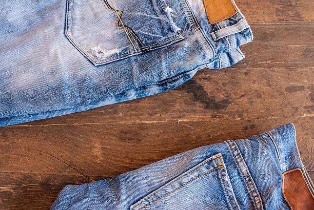 istock stack of various shades of blue jeans on old wood 501671734