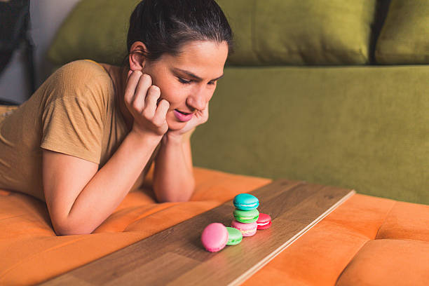 istock Woman looking at delicious macaroons 501671802