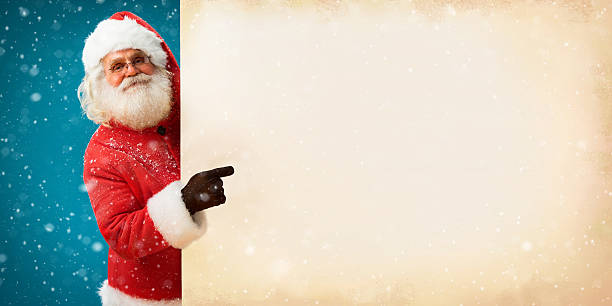 istock Smiling Santa Claus holding old paper banner 501672644