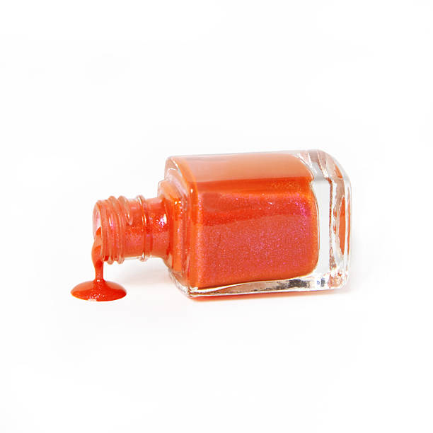 istock orange nail polish bottle dripping on white background 501673910