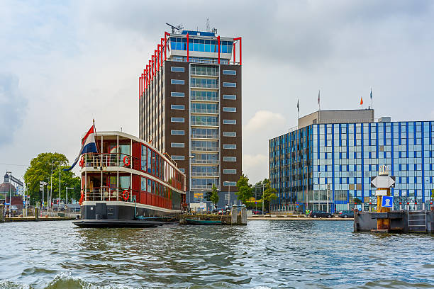 istock Amsterdam canal, boat and modern building, Holland 501673978