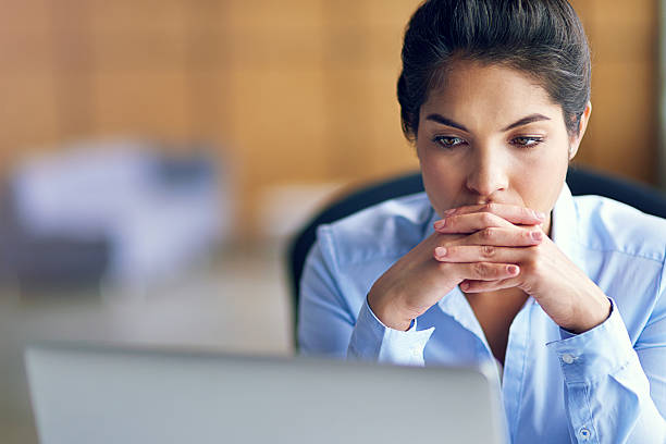 It's been a long day... Shot of a young businesswoman looking stressed while working on her laptophttp://195.154.178.81/DATA/i_collage/pi/shoots/806127.jpg the thinker stock pictures, royalty-free photos & images