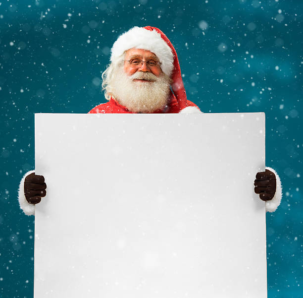 istock Real Santa Claus holding white blank sign for your text 501674368