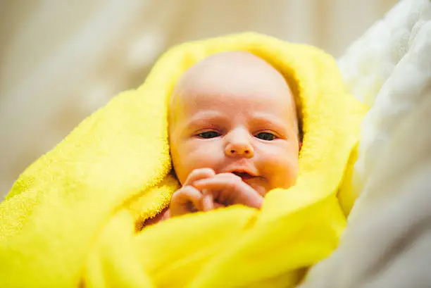 Photo of Crying small child lies on a bed