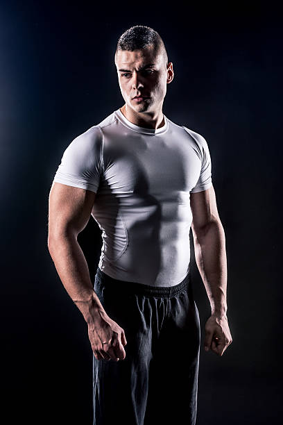 istock powerful male athlete in white shirt low-key 501678172