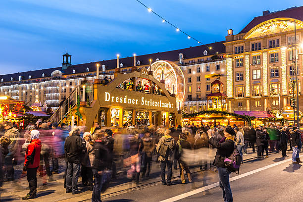 Dresden, Germany - December 12, 2015: People enjoy Christmas market in Dresden. It is Germany's oldest Christmas Market (called Striezelmarkt) with a very long history dating back to 1434. 