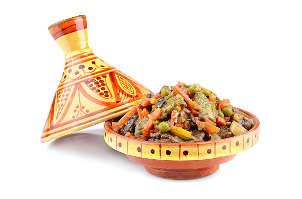 Moroccan tajine Tajine, Moroccan national dish with meat and vegetables on a white background tajine stock pictures, royalty-free photos & images