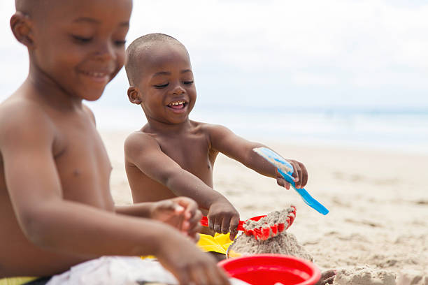 istock Two african brothers playing in the sand 501691047