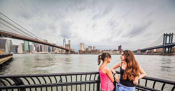 istock Two girls, sisters, looking to Manhattan under thunderstorm 501691245
