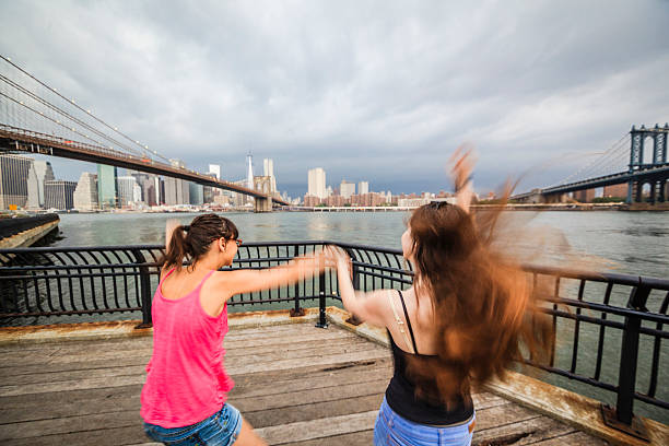 istock Two girls, sisters, looking to Manhattan under thunderstorm 501691351