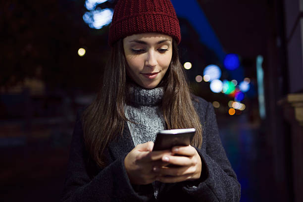 istock Portrait of young woman using her mobile phone at night. 501700320