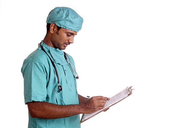 istock Smiling Indian young male medical worker writing in notepad 501701850