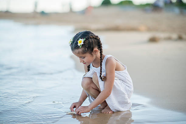 istock Little Girl Touching a Starfish 501702148
