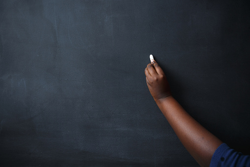 African woman hand draw on blackboard.