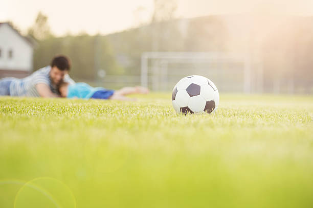 istock Father and son playing football 501705745