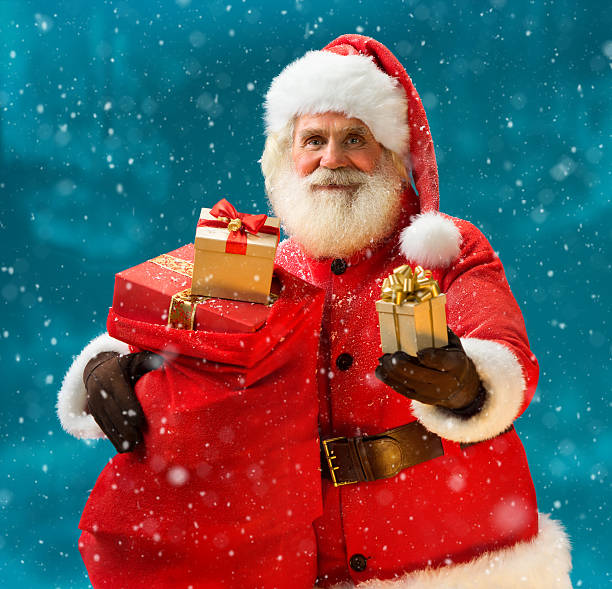 istock Happy and kind Santa Claus with christmas present 501706552
