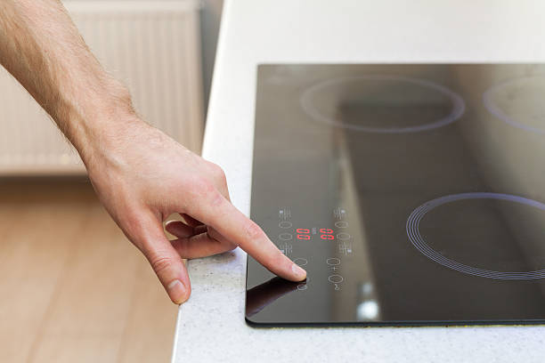 istock Close Up Of Hand Turning On Ceramic Stove 501706680