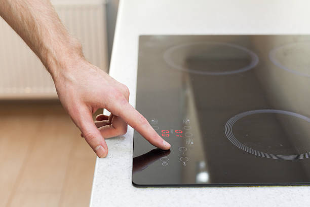 istock Close Up Of Hand Setting Temperature Control On Ceramic Stove 501706746