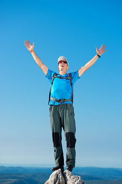 istock Man standing on top of a mountain with arms raised 501706810