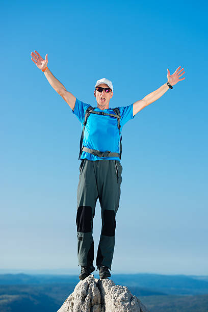 istock Man standing on top of a mountain with arms raised 501706854