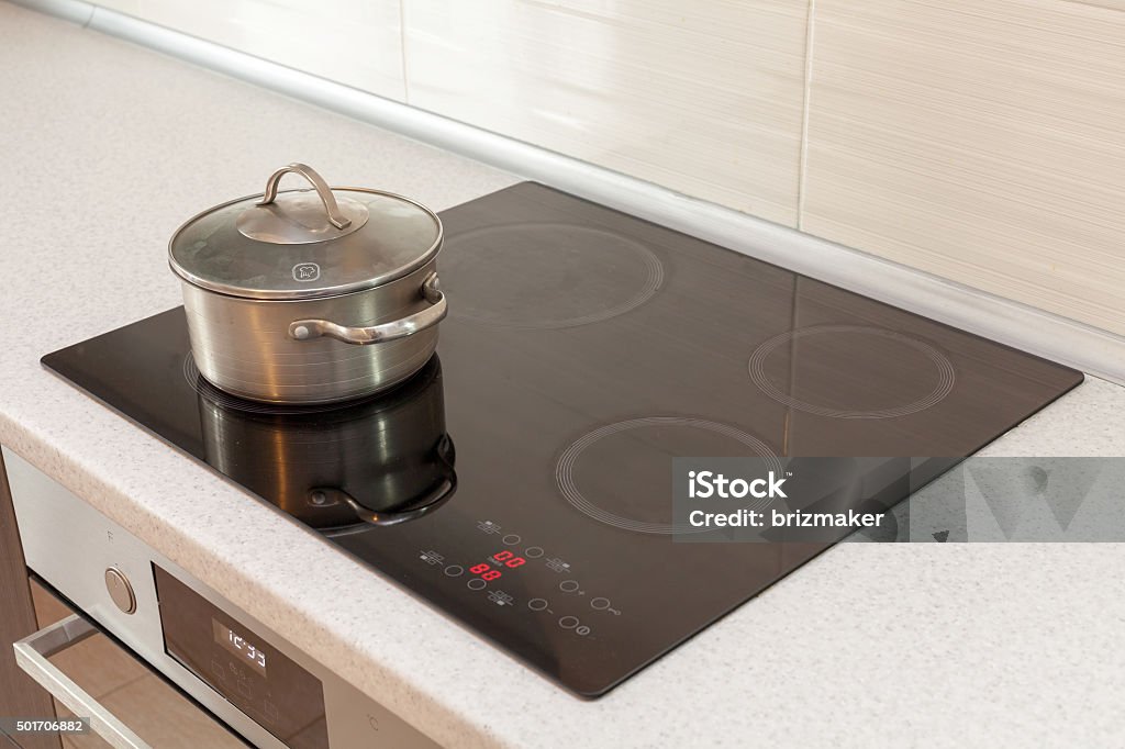 Metal steel saucepan in modern kitchen with induction stove 2015 Stock Photo