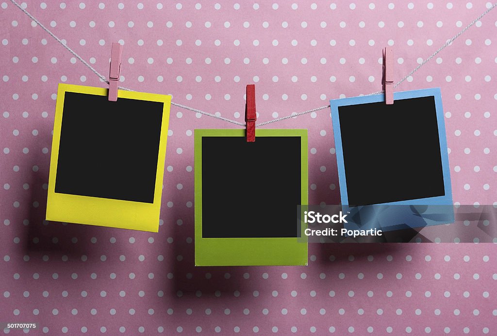 Color photo frames hanging Three instant photos on a dotted background. Instant Camera Stock Photo