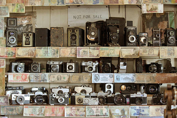 Maui, Hawaii, USA - July 18, 2013: Collection of vintage cameras and currency from all over the world on several shelves at a rest area.