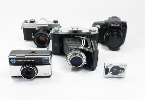 London, UK - July 2, 2014: Front view of variety of cameras from different generations.
