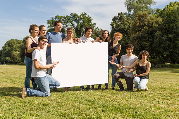 istock Friends holding blank sign in the park 501710361