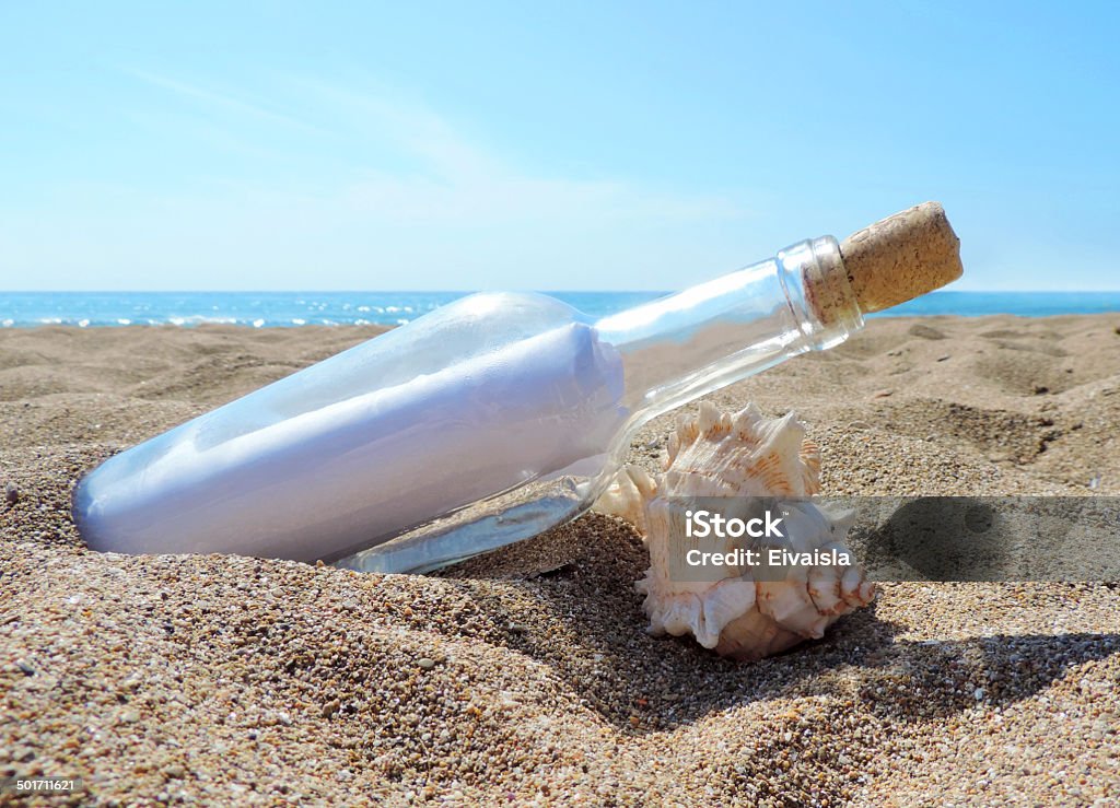 Message in a bottle Message in a bottle washed ashore the beach Assistance Stock Photo