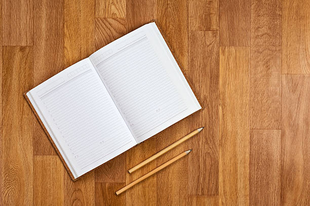 istock Blank notepad with office supplies on wooden table. 501711953