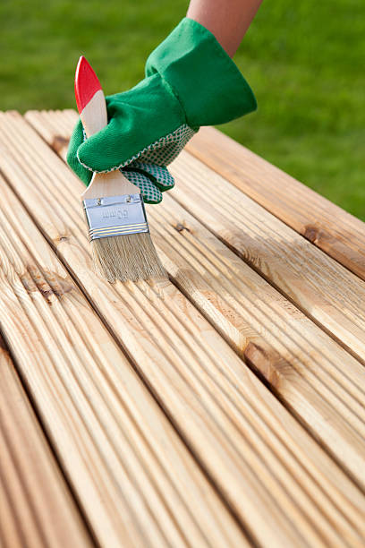 istock Hand with brush on a wooden background 501713281