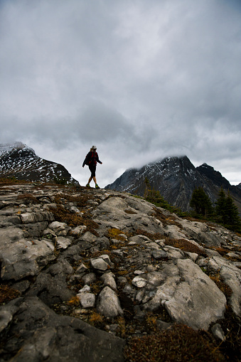A woman enjoys a rainy day hike in the Rocky Mountains of Canada.