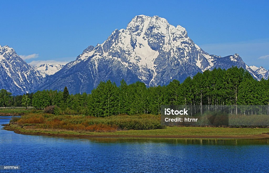 Grand Tetons Mt Moran and Jenny Lake in Wyoming USA Mount Moran with Jenny Lake in the foreground in the Grand Teton mountain range in the Grand Teton National Park in Wyoming USA during the spring / summer 2015 Stock Photo