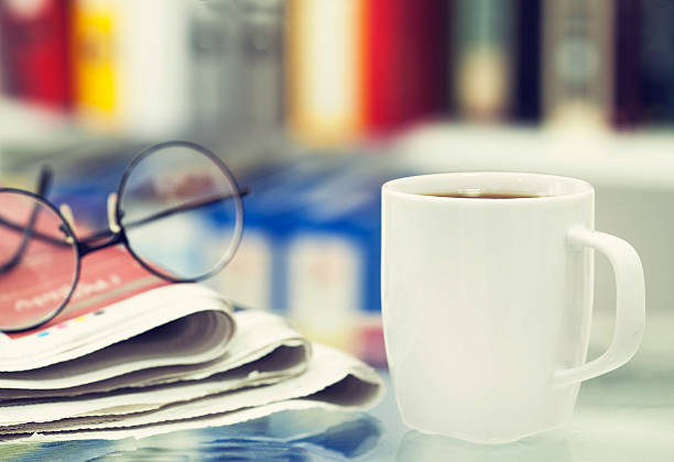 istock Cup of coffee and newspaper on table 501717734