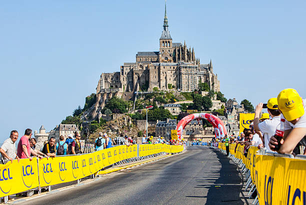 Spectators of Le Tour de France Le Mont Saint Michel,France-July 10, 2013: Spectators waiting for the peloton on the roadside during the stage 11 of the edition 100 of Le Tour de France 2013, a time trial between Avranches and Mont Saint Michel. mont saint michel photos stock pictures, royalty-free photos & images