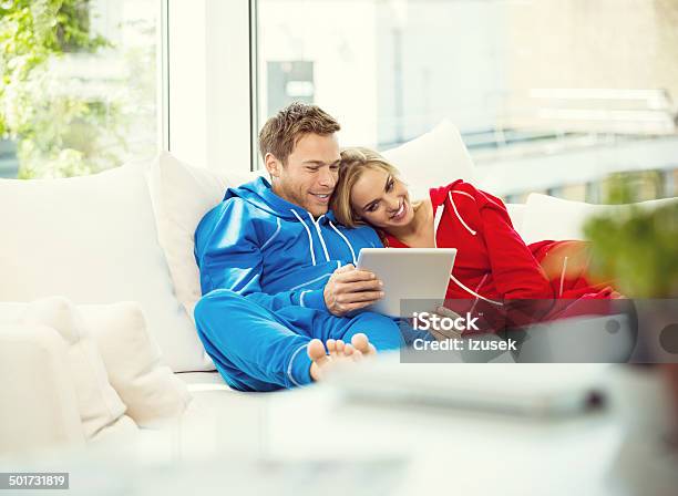 Young Couple Using A Digital Tablet Stock Photo - Download Image Now - Couple - Relationship, Luxury, Using Digital Tablet