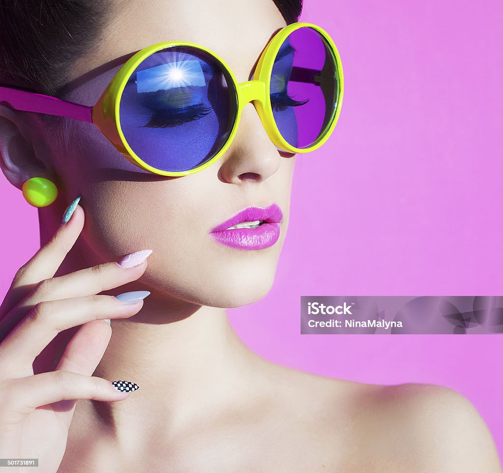 portrait of an attractive young woman with sunglasses Colorful summer portrait of an attractive young woman with sunglasses Fashion Stock Photo