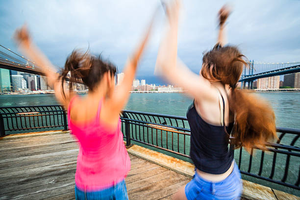 istock Two girls, sisters, looking to Manhattan under thunderstorm 501732749