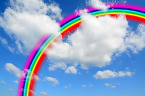 istock white clouds and blue sky with a colorful rainbow 501733031