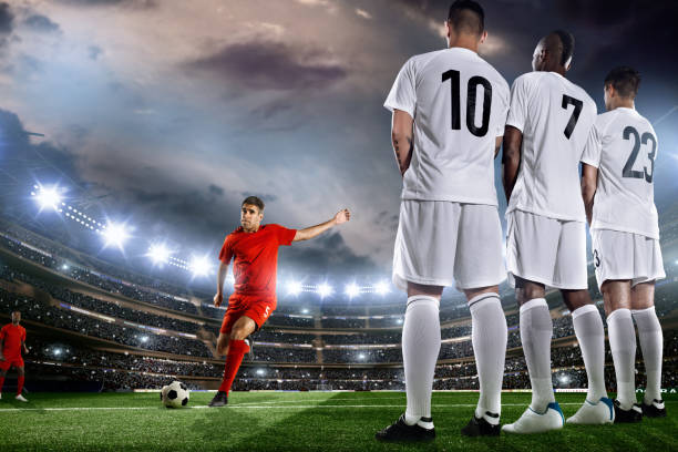 istock Soccer player kicks a ball in front of wall 501733643