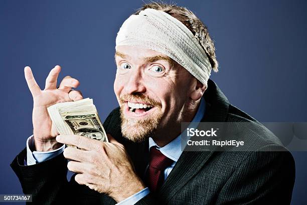 Bandaged Businessman Counts Money Gleefully Compensation Perhaps Stock Photo - Download Image Now