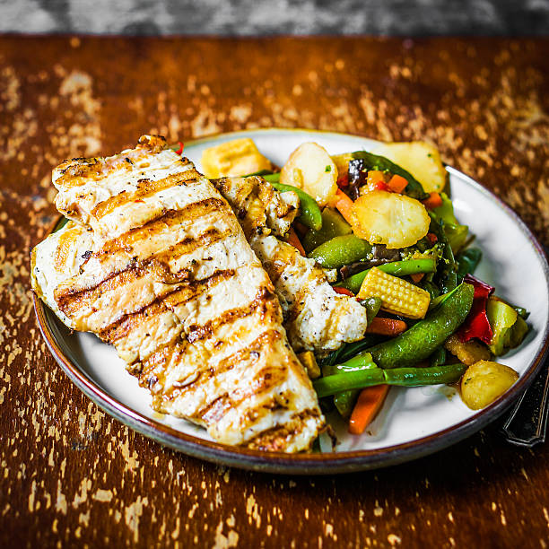 istock Grilled chicken with baked vegetables on rustic background 501735175