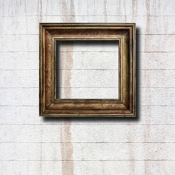 istock Gilded wooden frames for pictures on old stone wall 501735669