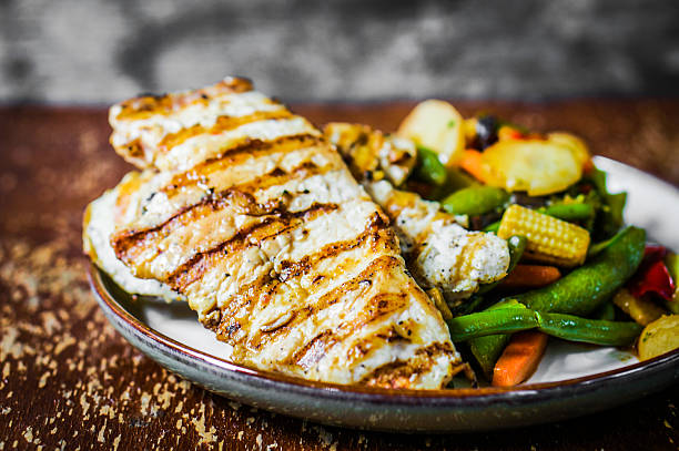 istock Grilled chicken with baked vegetables on rustic background 501735837