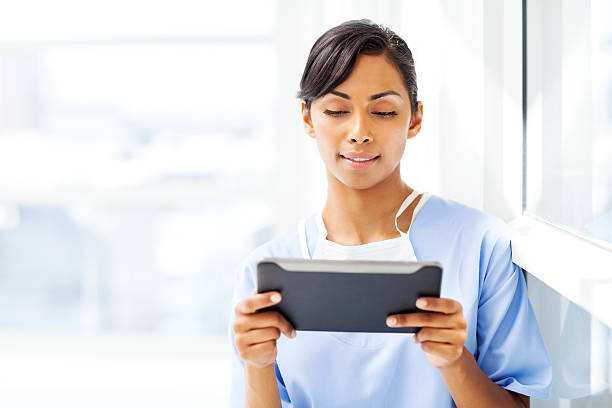 istock Beautiful Surgeon Using Digital Tablet In Hospital 501735975