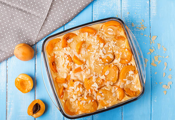 Apricot clafoutis Apricot clafoutis in the glass on the blue background, up view clafoutis stock pictures, royalty-free photos & images