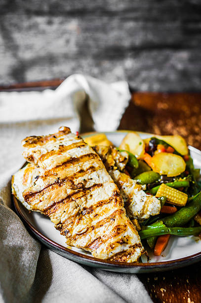 istock Grilled chicken with baked vegetables on rustic background 501736527