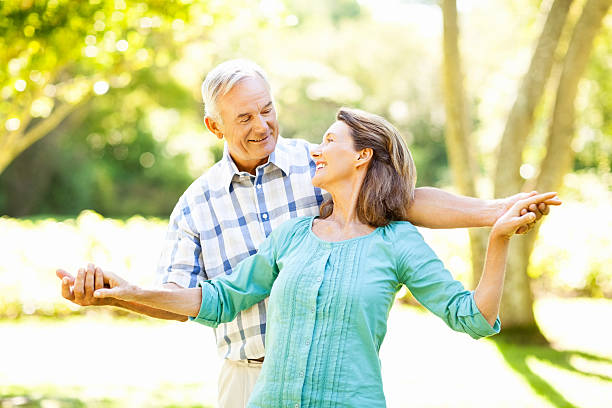 istock Romantic Senior Couple With Arms Outstretched In Park 501737897
